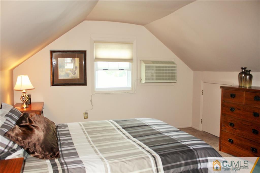 27 Ashley Road Edison, NJ 08817 - Photo 16 of 21 a bedroom with a bed and a dresser