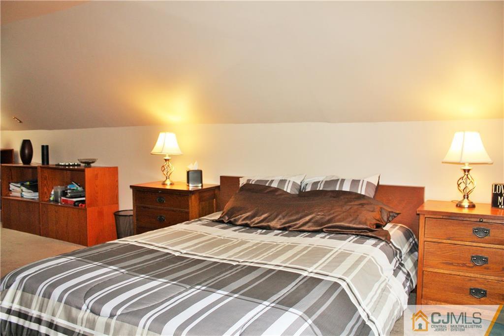 27 Ashley Road Edison, NJ 08817 - Photo 17 of 21 a bedroom with a bed and a lamp