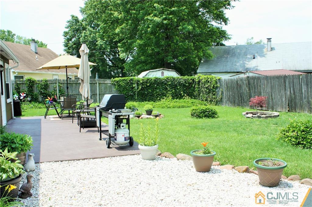 27 Ashley Road Edison, NJ 08817 - Photo 20 of 21 a view of a backyard with plants and a garden