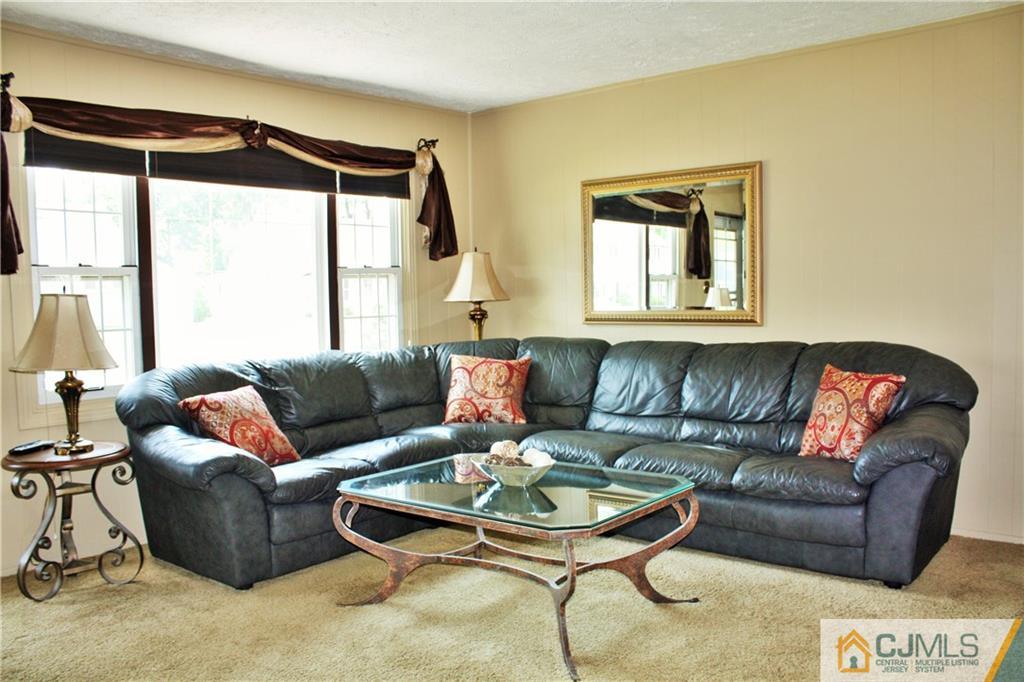 27 Ashley Road Edison, NJ 08817 - Photo 3 of 21 a living room with furniture and a large window
