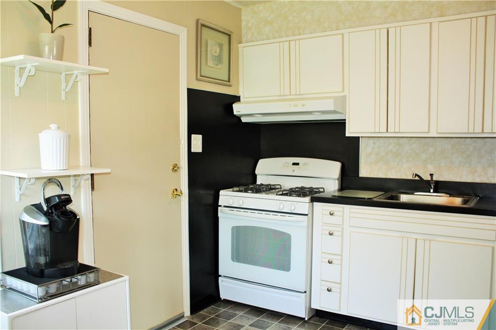 27 Ashley Road Edison, NJ 08817 - Photo 7 of 21 a kitchen with granite countertop a sink and a stove