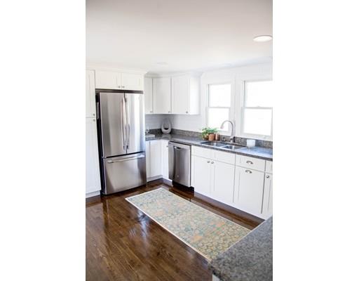696 Queen Anne Road Harwich, MA 02645 - Photo 9 of 18 a kitchen with a sink a refrigerator and cabinets