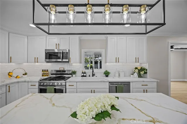 a kitchen with stainless steel appliances kitchen island granite countertop a sink and cabinets