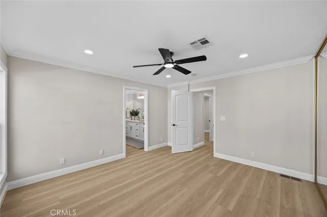 a spacious en suite bathroom with a granite countertop sink mirror and bathtub