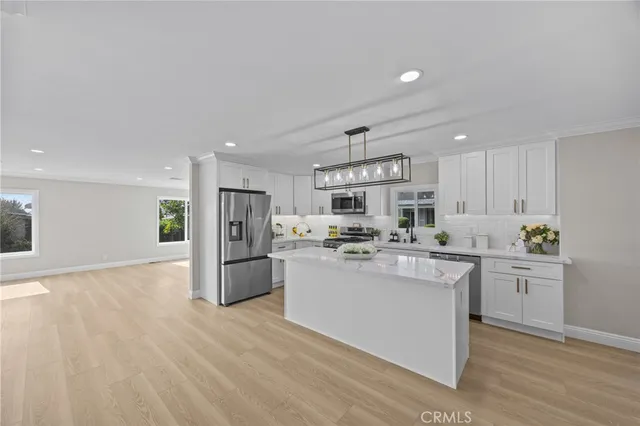 a kitchen with refrigerator and cabinets