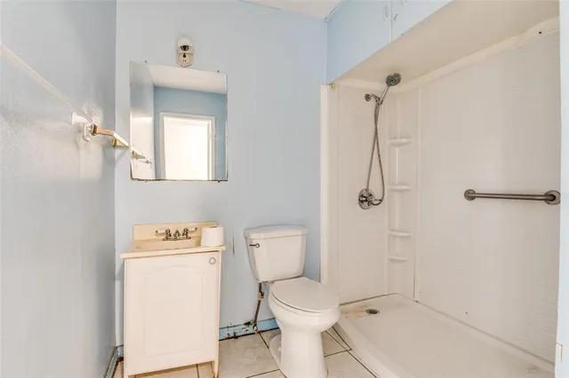 a white toilet sitting next to a bath tub
