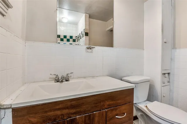 a bathroom with a sink a toilet and a mirror