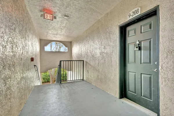 a view of a hallway to a livingroom with furniture