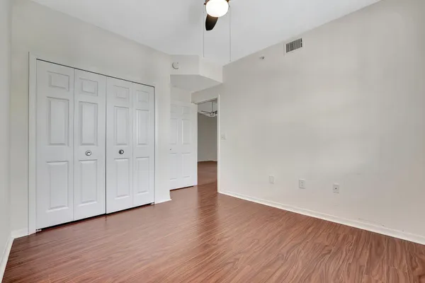 a view of an empty room with wooden floor