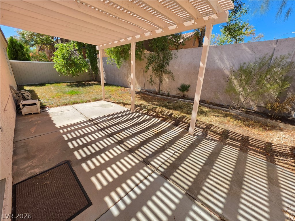 9609 Crystal Ridge Road Las Vegas, NV 89123 - Photo 2 of 21 An inviting covered patio opens up to a private walled yard with mature trees.