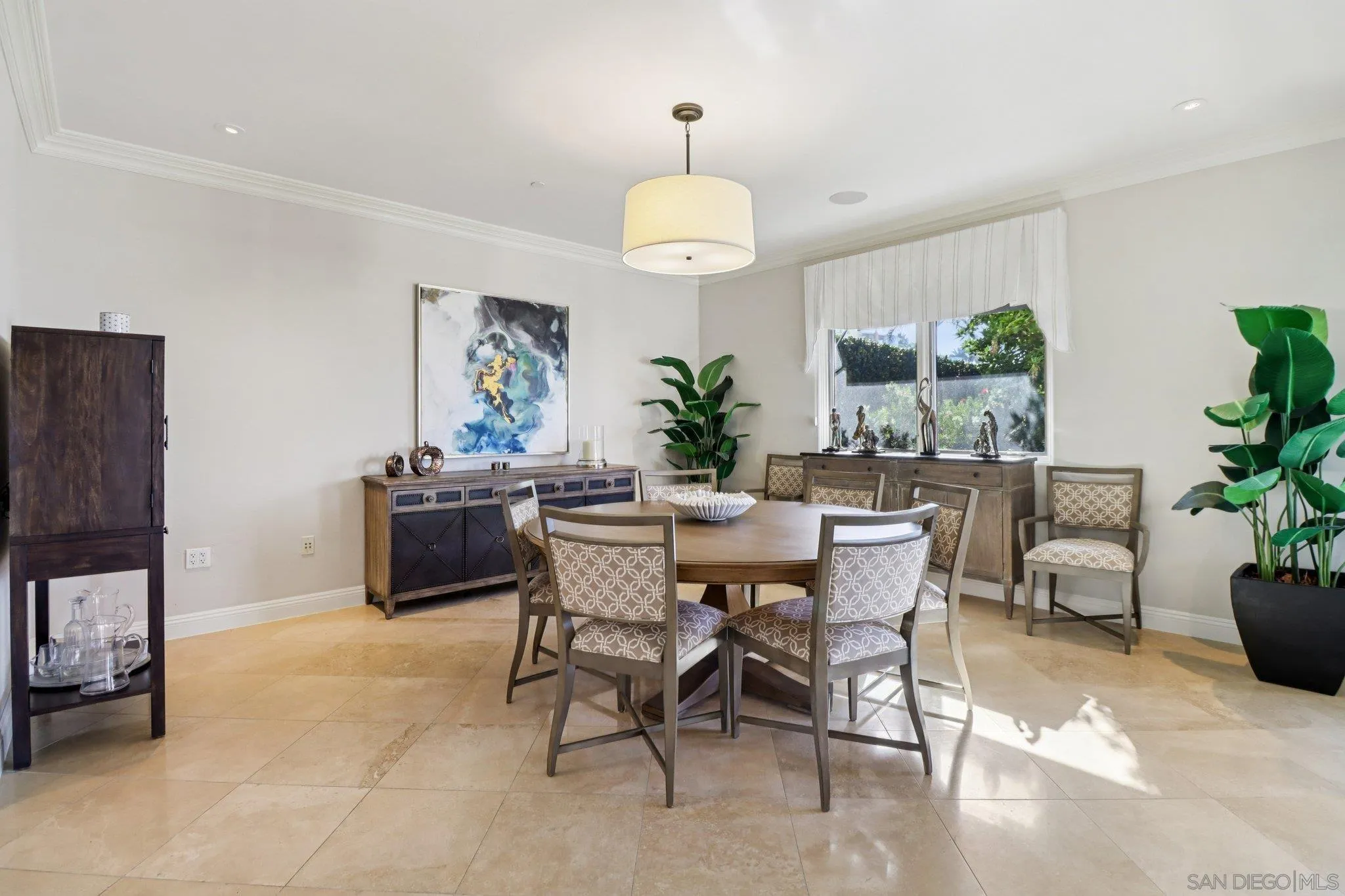 464 Prospect Street, Unit 101 La Jolla, CA 92037 - Photo 13 of 65 a view of a dining room with furniture and a potted plant
