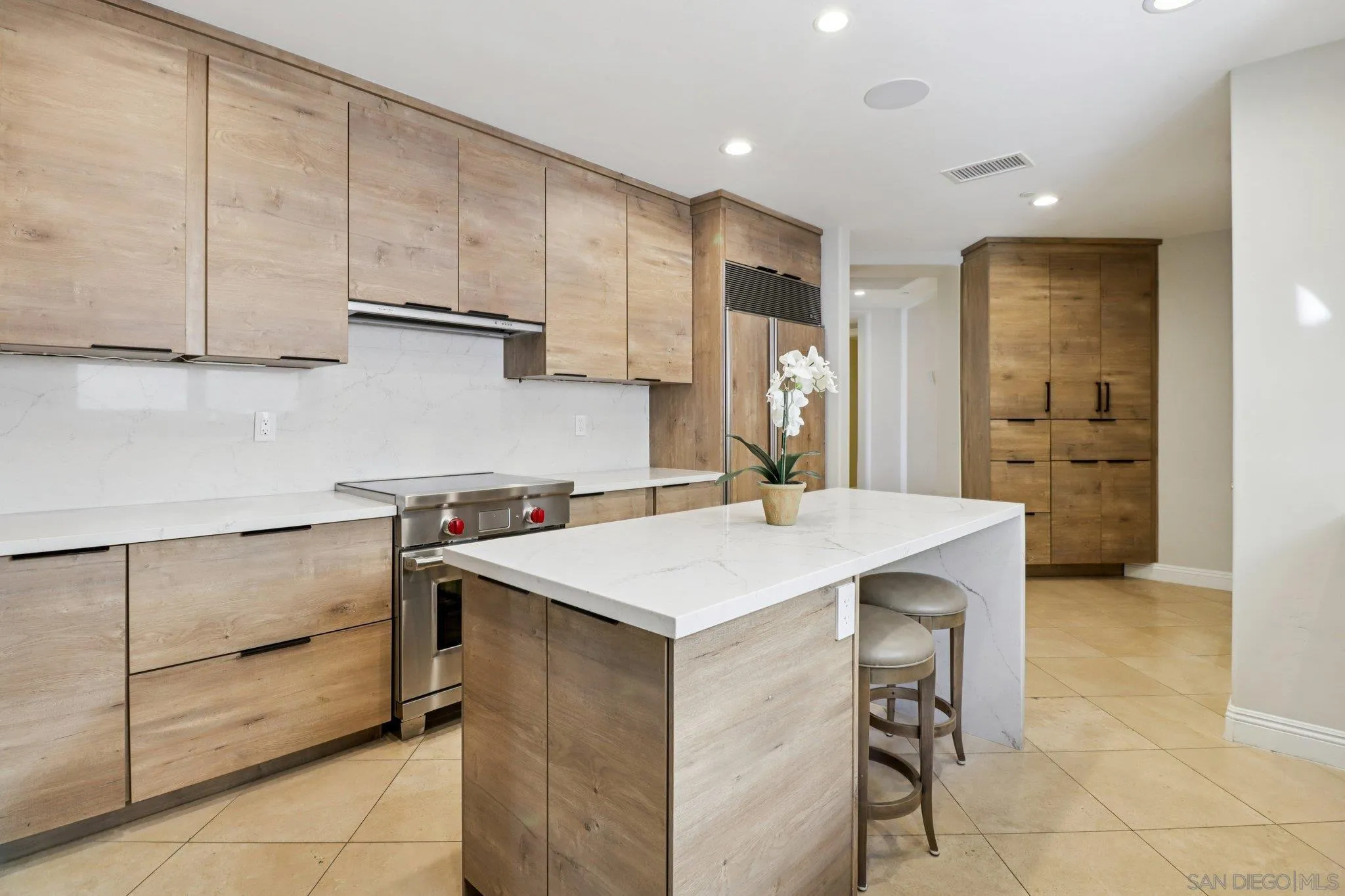464 Prospect Street, Unit 101 La Jolla, CA 92037 - Photo 14 of 65 a kitchen with a sink a stove a refrigerator and cabinets