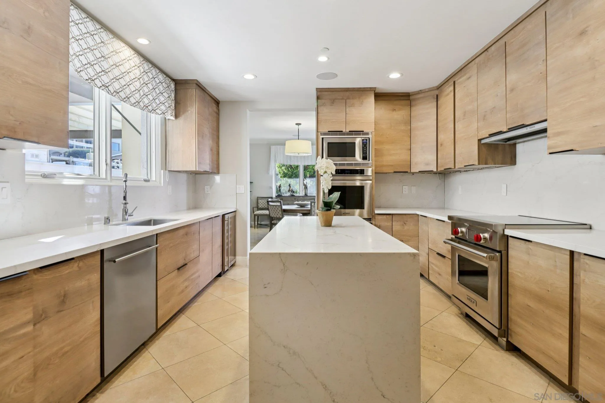 464 Prospect Street, Unit 101 La Jolla, CA 92037 - Photo 15 of 65 a kitchen with kitchen island sink stove microwave and cabinets