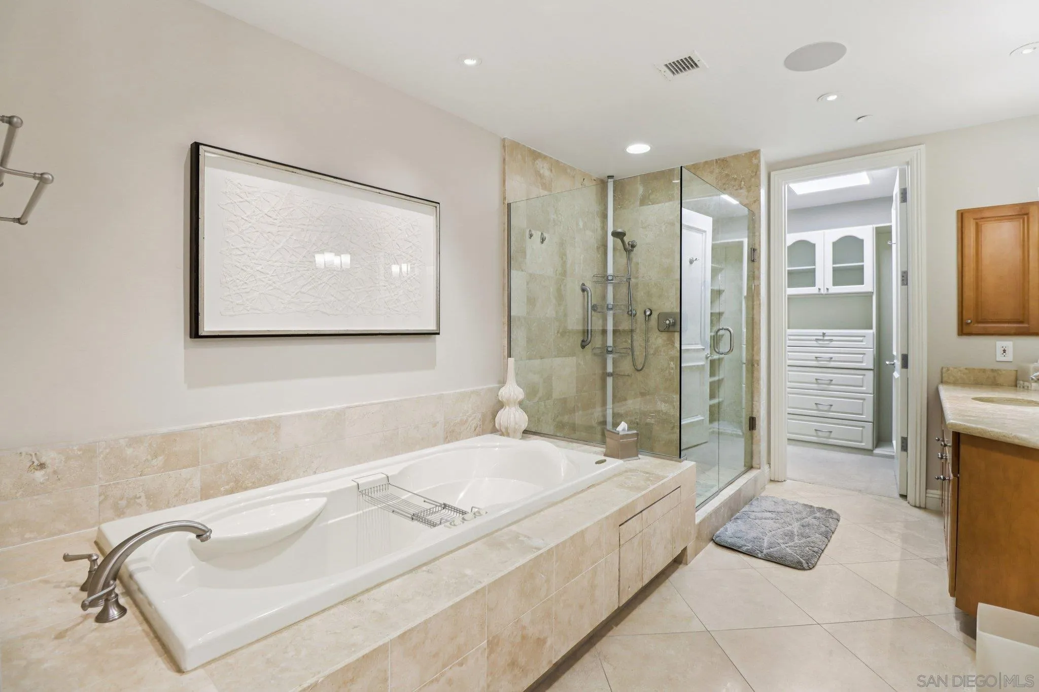 464 Prospect Street, Unit 101 La Jolla, CA 92037 - Photo 24 of 65 a spacious bathroom with a tub sink and mirror