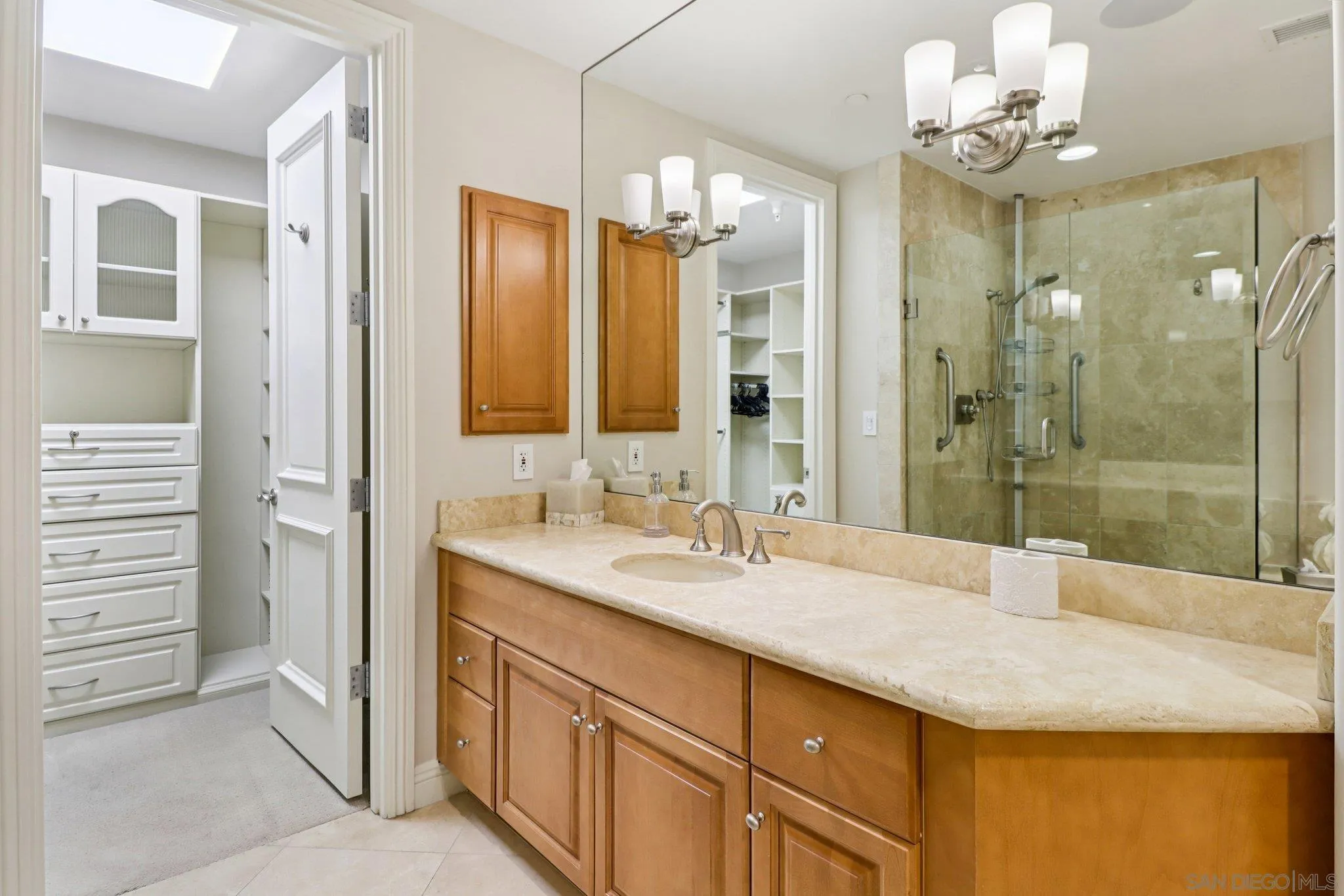464 Prospect Street, Unit 101 La Jolla, CA 92037 - Photo 27 of 65 a bathroom with a granite countertop sink a mirror and a shower