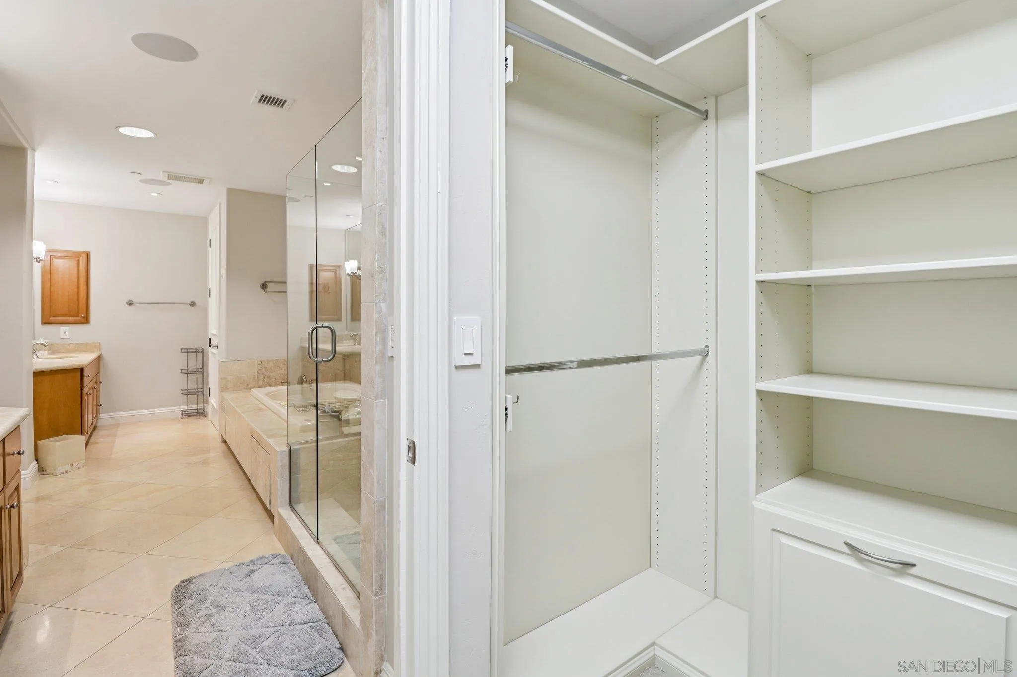 464 Prospect Street, Unit 101 La Jolla, CA 92037 - Photo 28 of 65 a bathroom with a glass shower door