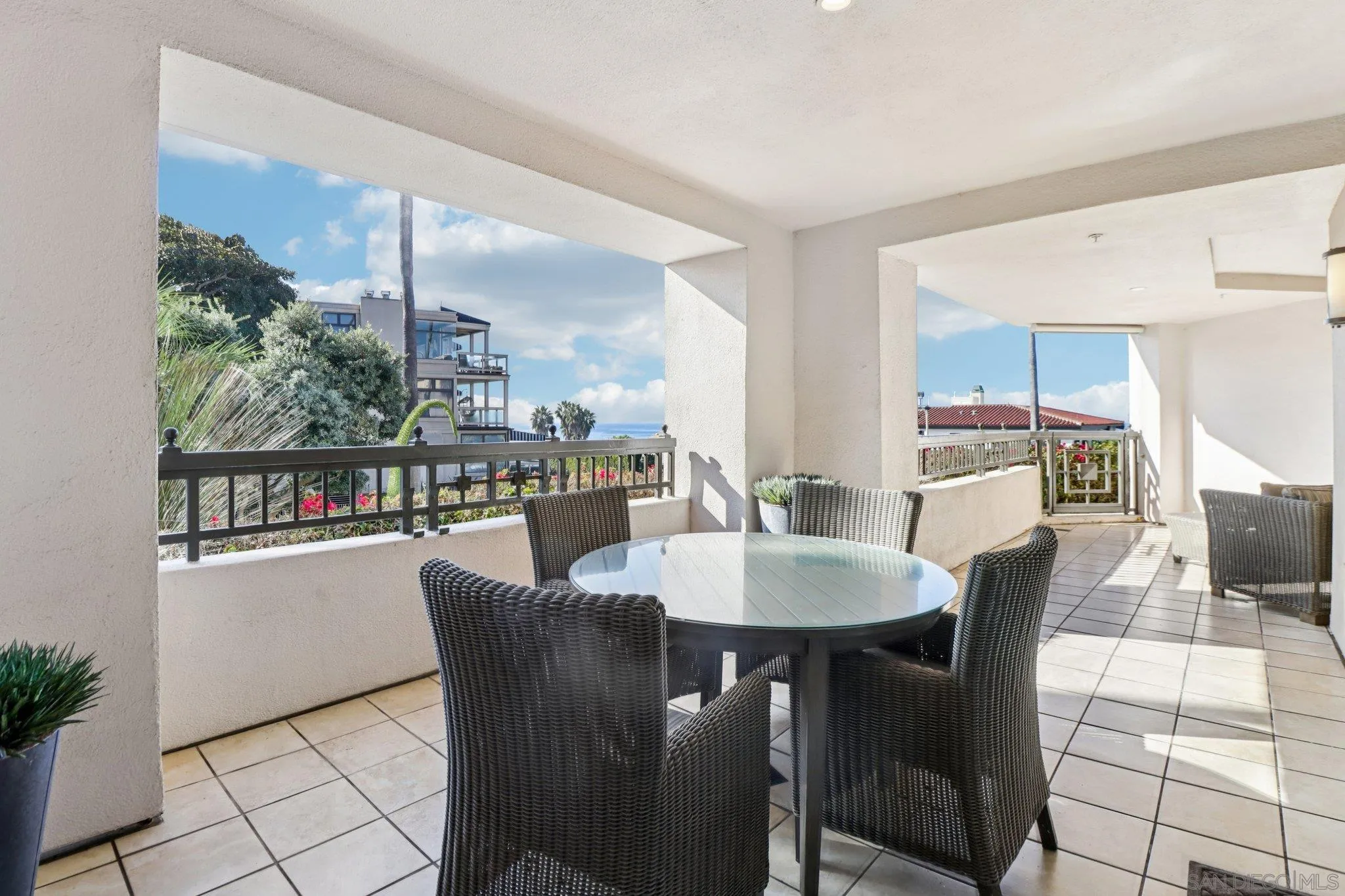 464 Prospect Street, Unit 101 La Jolla, CA 92037 - Photo 38 of 65 a dining room with furniture a floor to ceiling window and potted plants