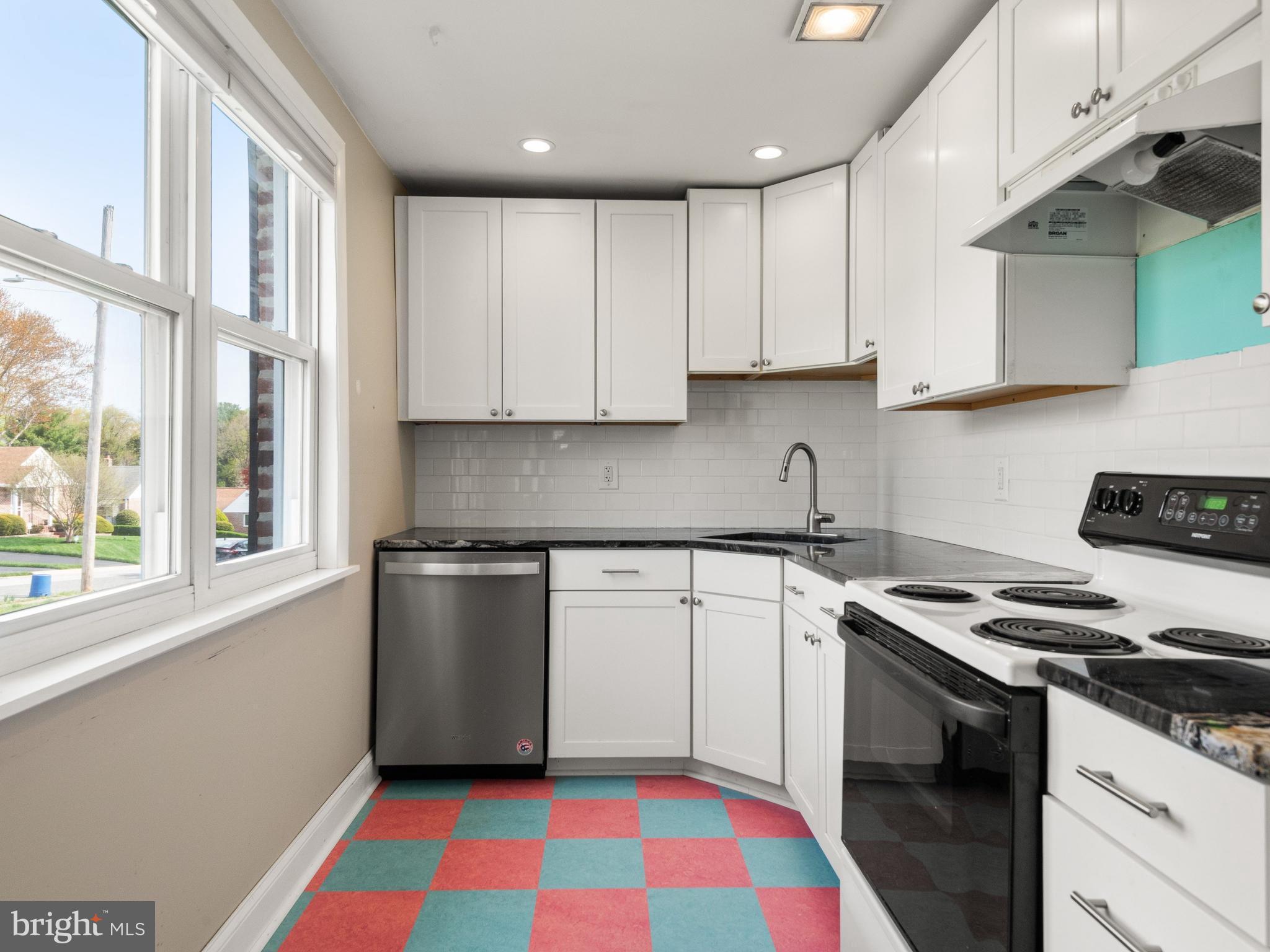 23 Pleasant Road Broomall, PA 19008 - Photo 11 of 36 a kitchen with stainless steel appliances granite countertop a sink stove and cabinets