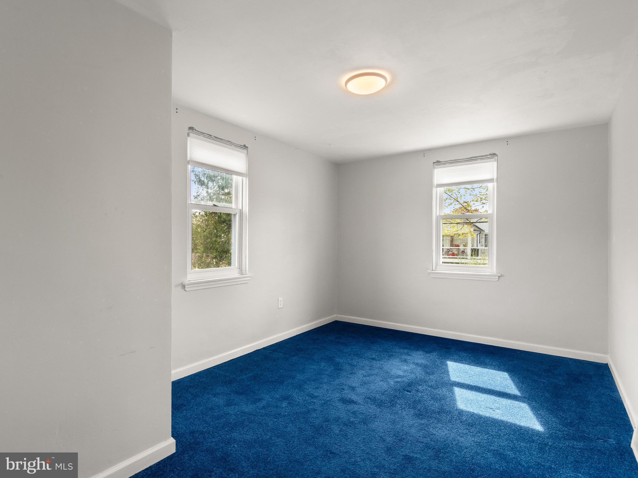 23 Pleasant Road Broomall, PA 19008 - Photo 17 of 36 an empty room with wooden floor and windows