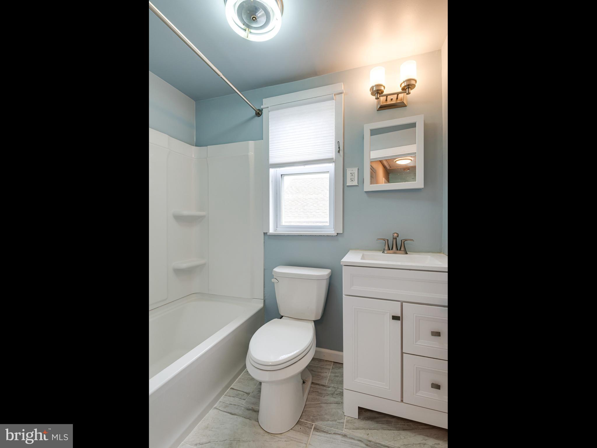 23 Pleasant Road Broomall, PA 19008 - Photo 19 of 36 a bathroom with a toilet sink and mirror