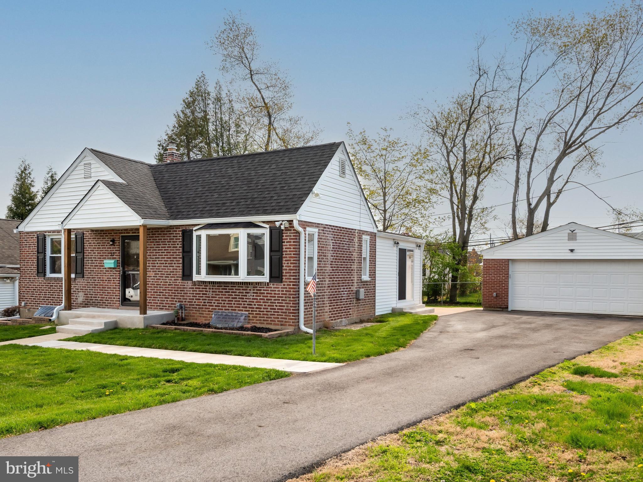 23 Pleasant Road Broomall, PA 19008 - Photo 2 of 36 a front view of a house with a yard and garage