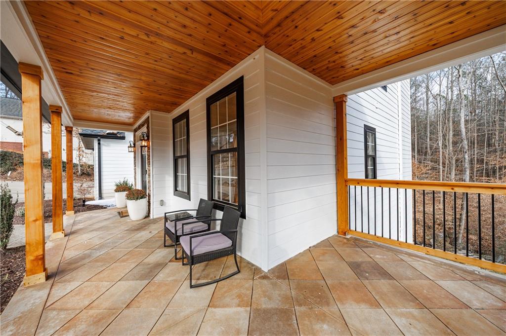 4049 Ashford Way Gainesville, GA 30507 - Photo 13 of 74 a view of a patio with table and chairs and wooden floor
