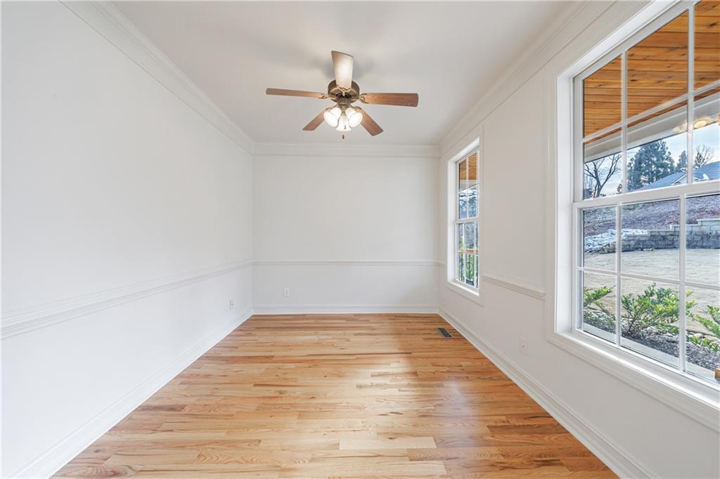 4049 Ashford Way Gainesville, GA 30507 - Photo 16 of 74 a view of empty room with wooden floor and fan