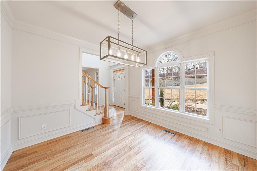 4049 Ashford Way Gainesville, GA 30507 - Photo 21 of 74 a view of a big room with wooden floor windows and entryway
