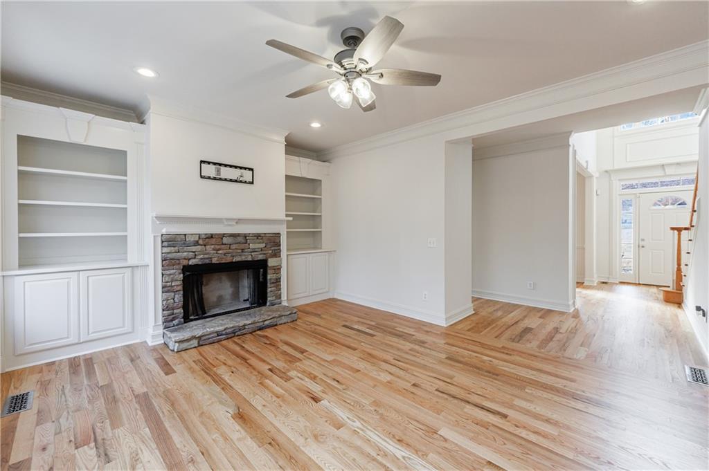 4049 Ashford Way Gainesville, GA 30507 - Photo 24 of 74 a view of empty room with a fireplace and wooden floor