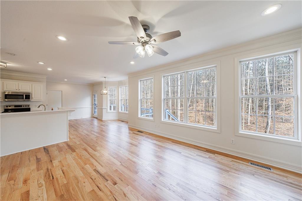 4049 Ashford Way Gainesville, GA 30507 - Photo 27 of 74 a view of an empty room with wooden floor and a window