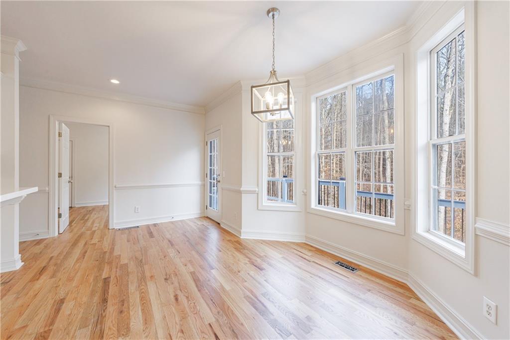 4049 Ashford Way Gainesville, GA 30507 - Photo 28 of 74 a view of empty room with wooden floor and windows