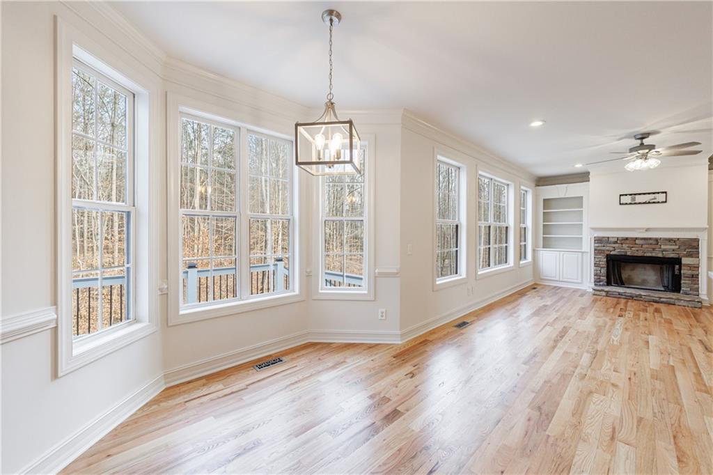 4049 Ashford Way Gainesville, GA 30507 - Photo 29 of 74 a view of an empty room with wooden floor fireplace and a window