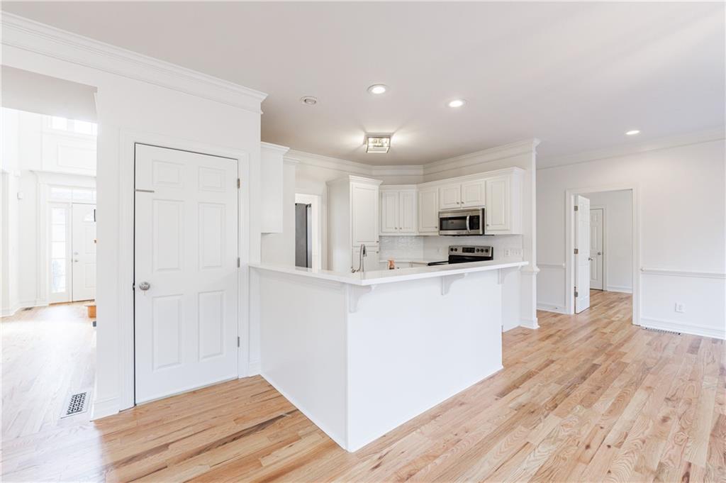 4049 Ashford Way Gainesville, GA 30507 - Photo 32 of 74 a kitchen with white cabinets and refrigerator