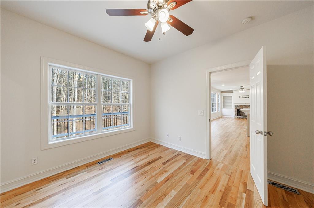 4049 Ashford Way Gainesville, GA 30507 - Photo 37 of 74 a view of empty room with wooden floor and fan