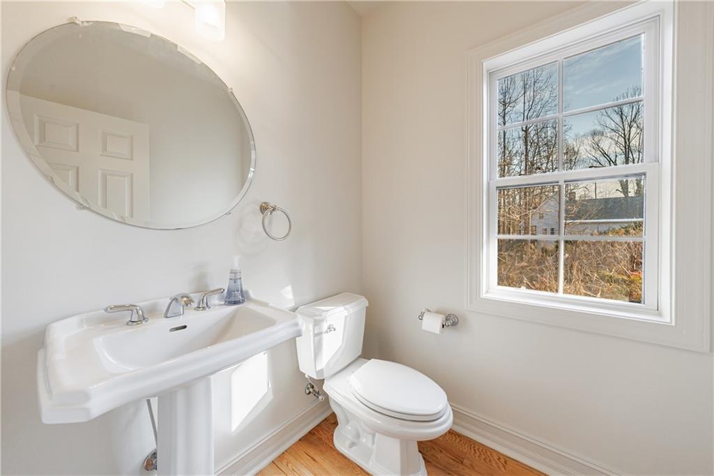 4049 Ashford Way Gainesville, GA 30507 - Photo 39 of 74 a bathroom with a sink a mirror and a toilet
