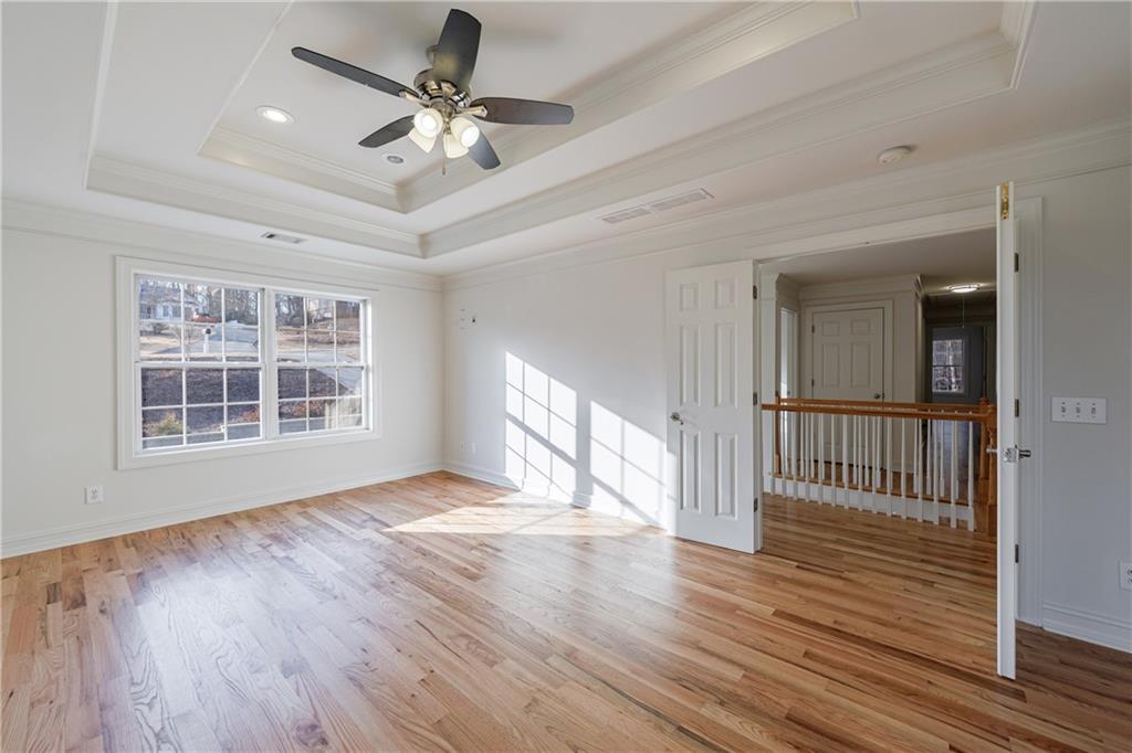 4049 Ashford Way Gainesville, GA 30507 - Photo 44 of 74 a view of an empty room with wooden floor and a window