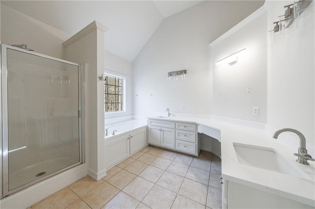 4049 Ashford Way Gainesville, GA 30507 - Photo 46 of 74 a large white bathroom with a granite countertop sink a toilet and shower