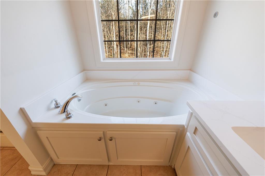 4049 Ashford Way Gainesville, GA 30507 - Photo 49 of 74 a bathroom with bathtub and window