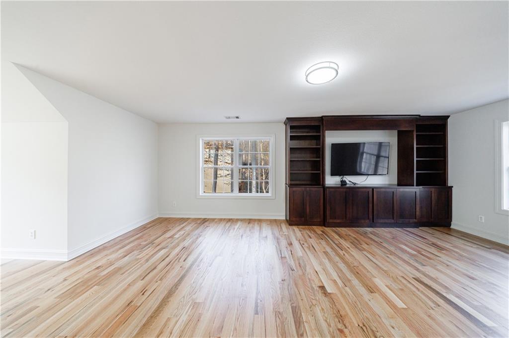 4049 Ashford Way Gainesville, GA 30507 - Photo 58 of 74 wooden floor in an empty room with a window