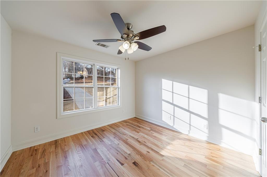 4049 Ashford Way Gainesville, GA 30507 - Photo 62 of 74 a view of an empty room with a window and wooden floor