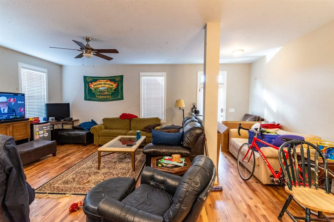 928 Chaney Road Raleigh, NC 27606 - Photo 6 of 7 a living room with furniture a rug and a flat screen tv