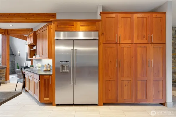 a kitchen with a sink a counter top space and living room view