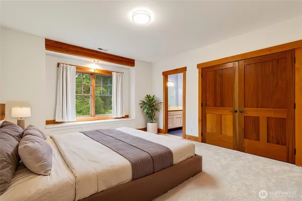 a bedroom with a large bed and a window