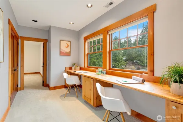 a living room with furniture and large windows