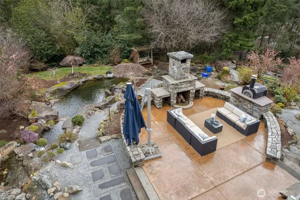 a view of backyard with a table and chairs under an umbrella