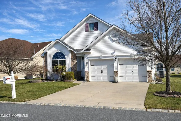 a view of house with yard and tree in front of it