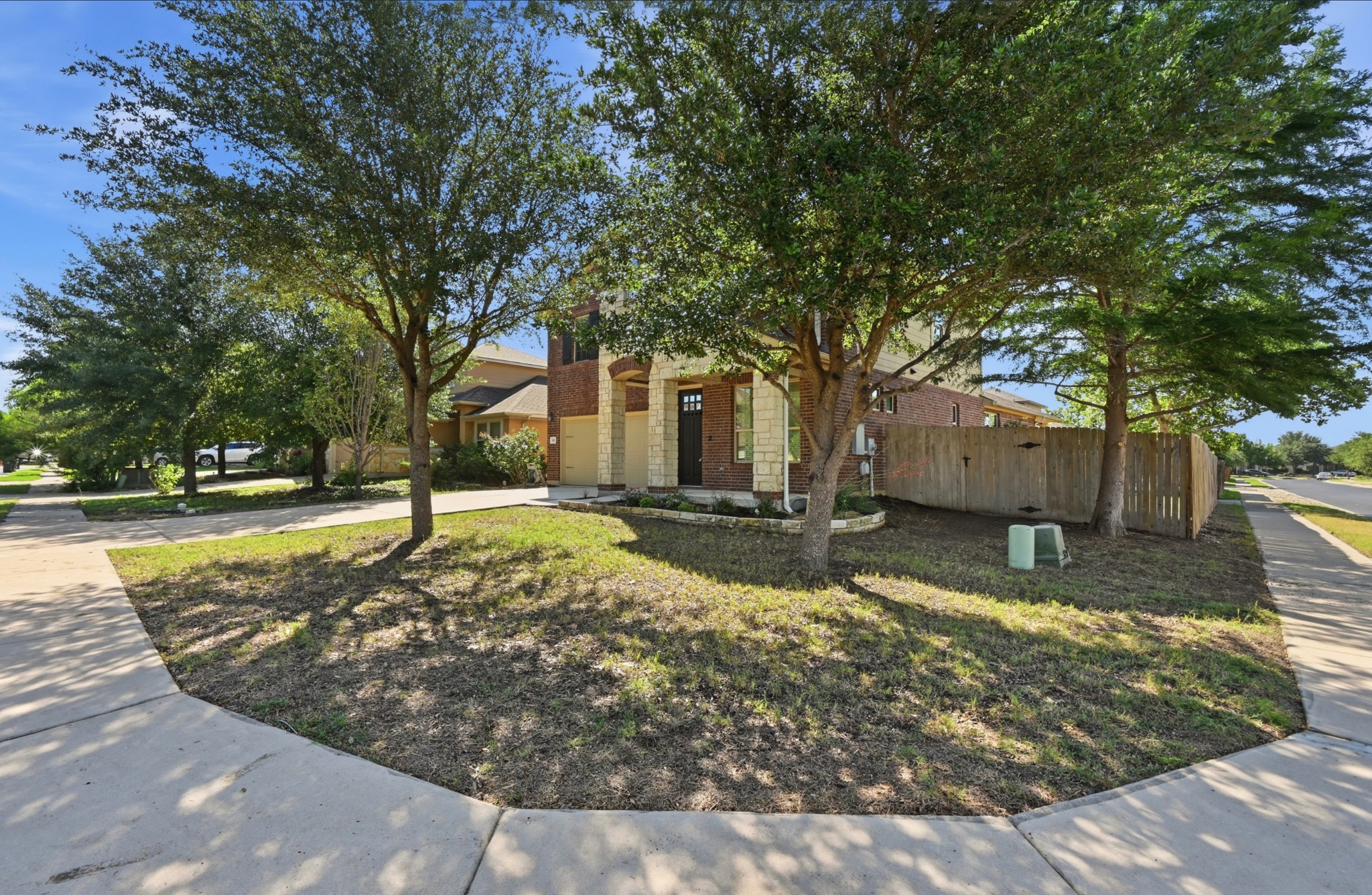 351 Wincliff Drive Buda, TX 78610 - Photo 2 of 40 A well-maintained lawn and mature trees enhance the curb appeal of this inviting two-story residence.