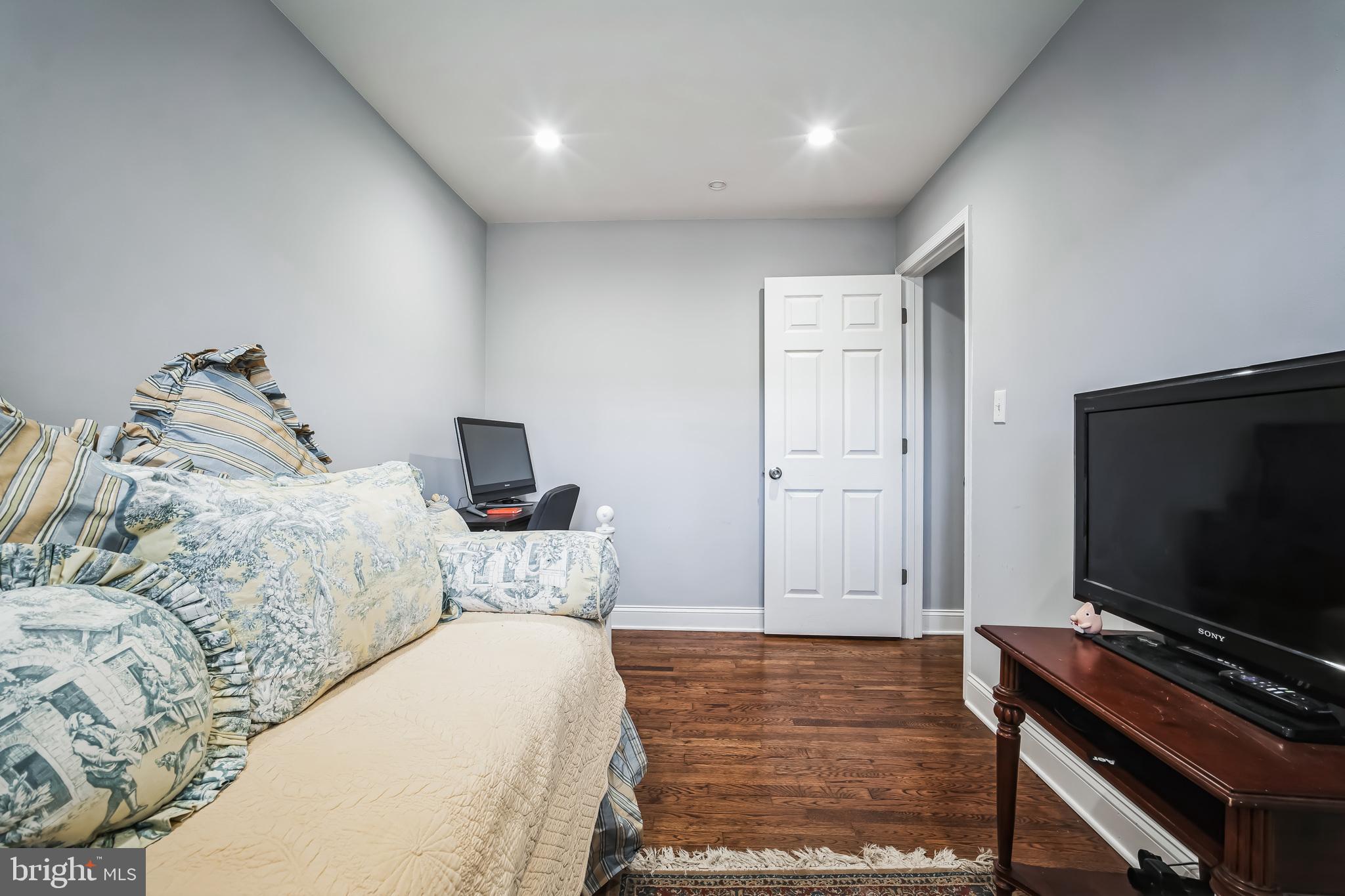 7113 Evanston Road Springfield, VA 22150 - Photo 17 of 30 a bedroom with a bed and a flat screen tv