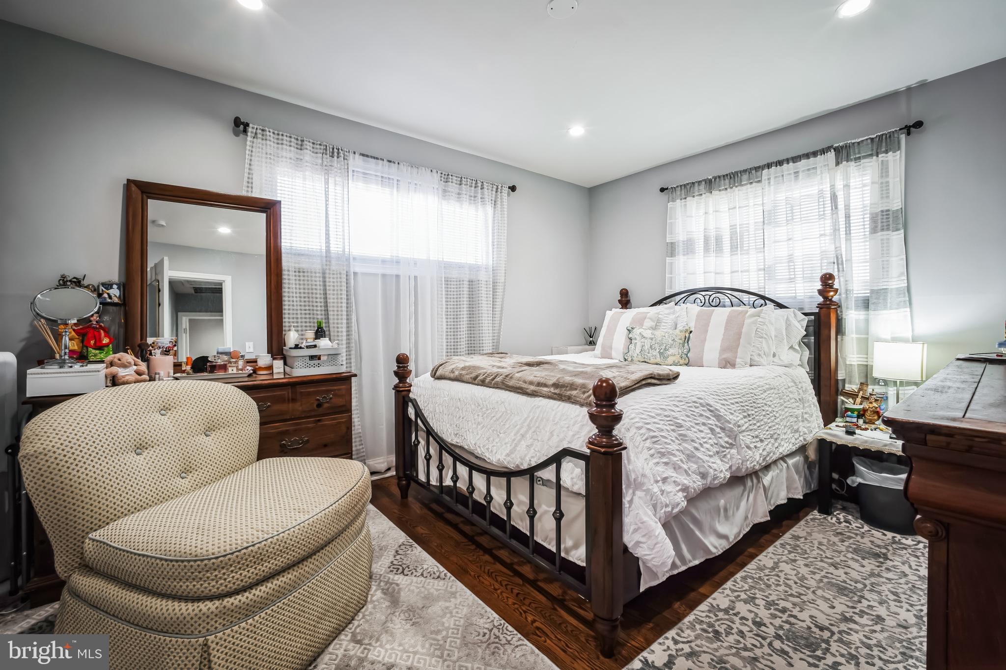 7113 Evanston Road Springfield, VA 22150 - Photo 21 of 30 a bedroom with a bed a mirror and a large window