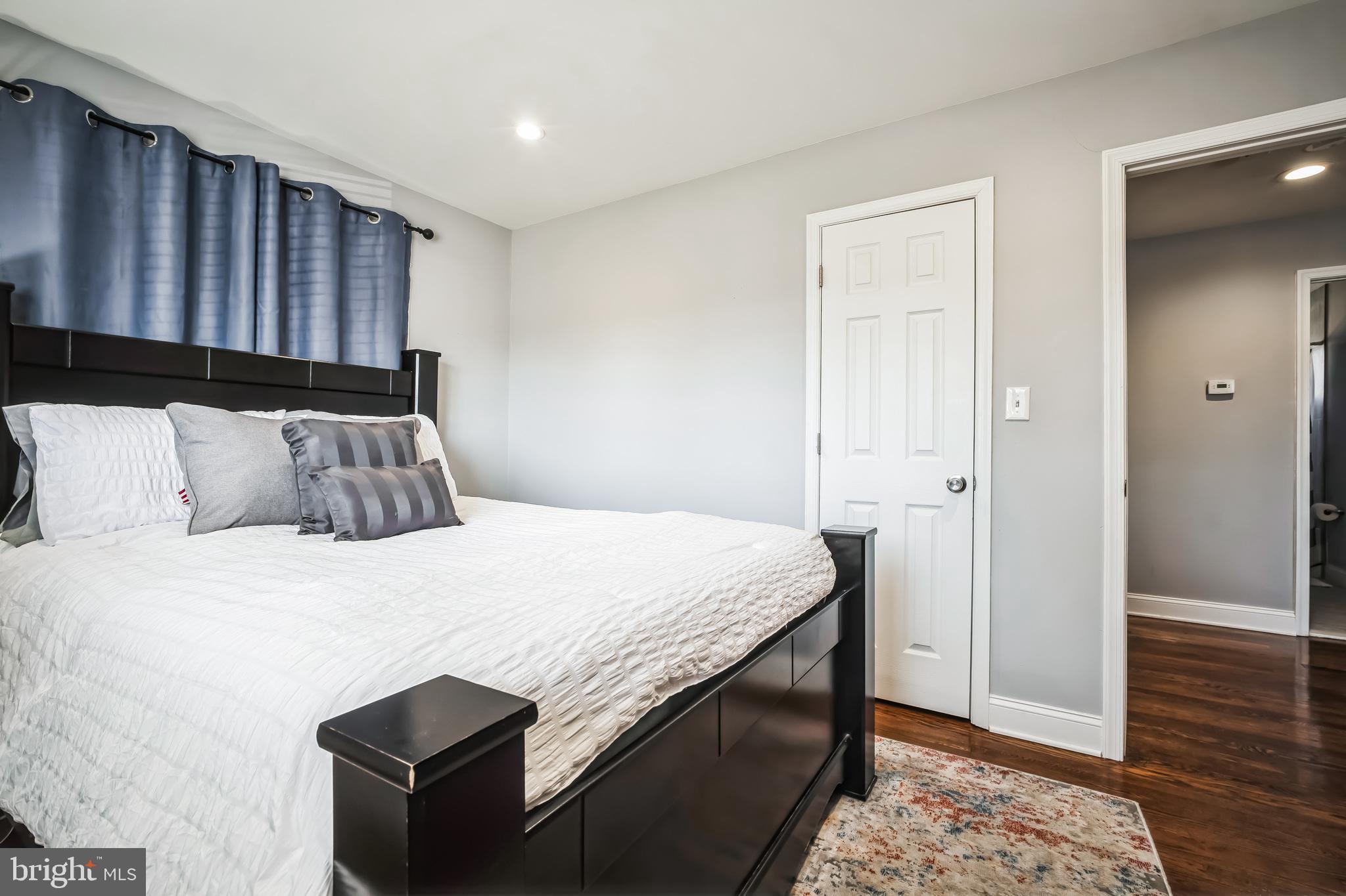 7113 Evanston Road Springfield, VA 22150 - Photo 30 of 30 a bedroom with a bed and wooden floor